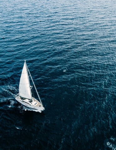 Aerial View Of Sailing Ship Yachts With White Sails In Windy Con